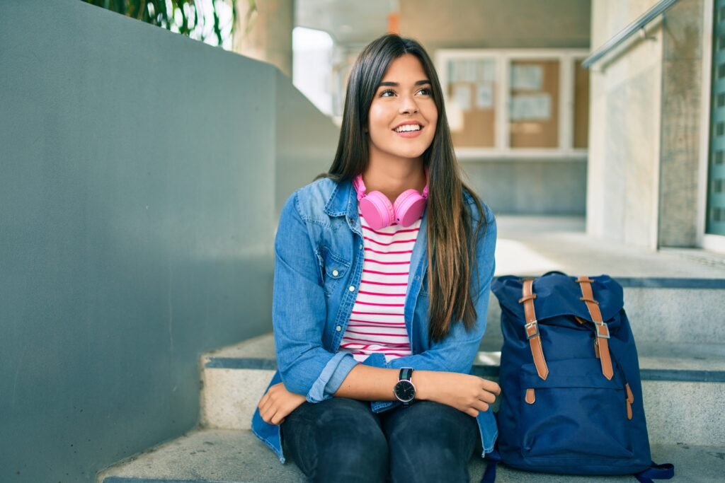 young hispanic student girl smiling happy at the university.